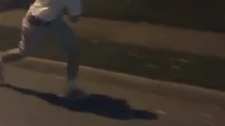 Guy in white shirt runs and jumps on a white car