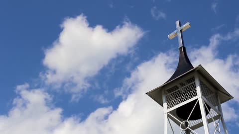 Guitar music with sounds of birds and bell tower.