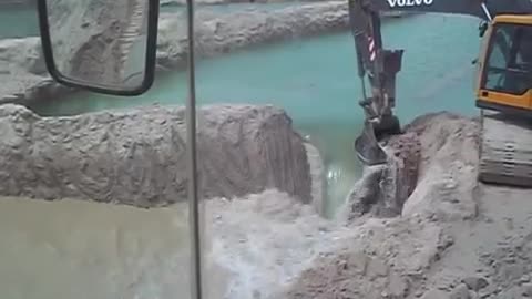 Volvo Excavator Breaks Down a Small Dam