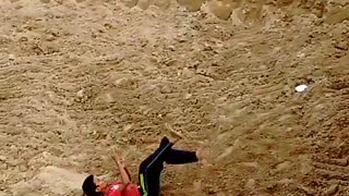 Kid in red shirt black pants backflip fail onto dirt