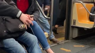 Man brown jacket signing subway doors open