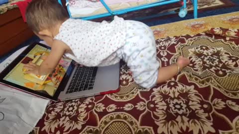 A cute baby is playing with Macbookpro !!!