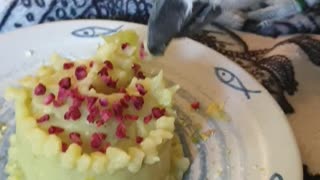 Parrot eating birthday cake