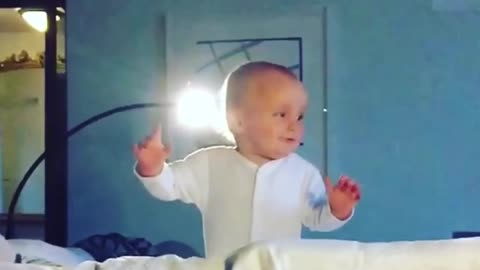 Cute little boy learning to stand up - falls repeatedly