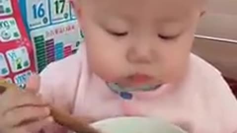 baby eating with very cute chopstick