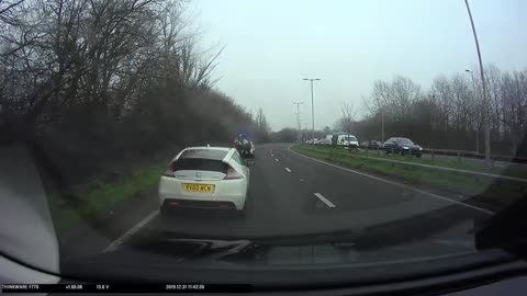 Car zips wrong way through roundabout - then catches fire