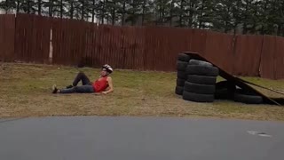 Red shirt white helmet does scooter backflip fail on tire ramp