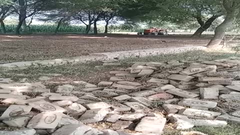 Beautiful village view tractor preparing field