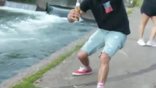 Guy in black shirt almost falls nearly spills beer