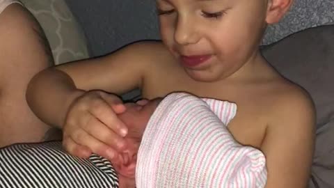 2 Year Old Holds His Baby Sister For The First Time. And It’s Priceless.