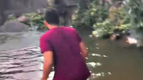 Parked car rolls over waterfall