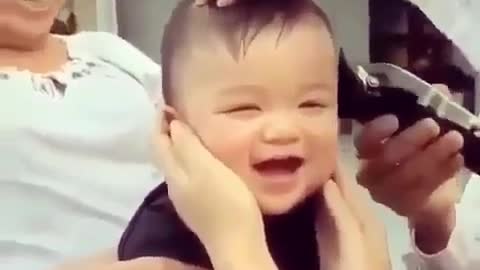 Funny baby whose hair is cut short