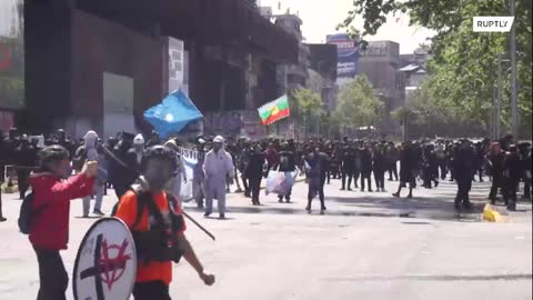 Thousands of indigenous protesters face water cannons and tear gas in Santiago