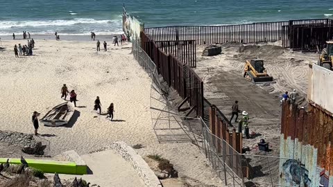Migrants and Stray Dog Run Across Open US-Mexico Border Fence in Tijuana