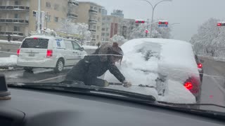 Cleaning Snow Off Stranger's Back Window