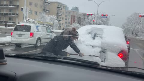 Cleaning Snow Off Stranger's Back Window