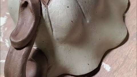 Carving onto a teacup.