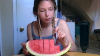 Girl eats a huge piece of watermelon