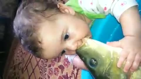 Little Boy Playing With a Fish