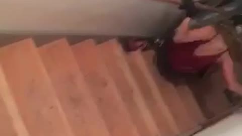 Red shirt girl skis down stairs