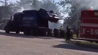 Garbage Truck Dumps Burning Load into Fire Station Parking Lot