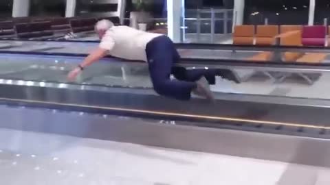 Old Man Swimming on Escalator decided to make his time on an escalator more fun
