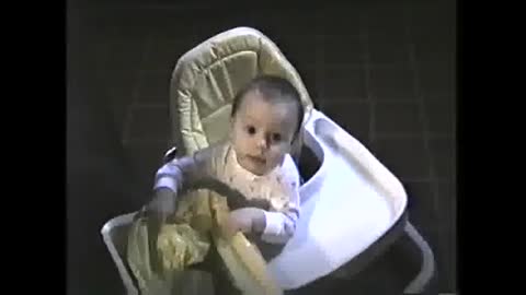 Cute baby plays with waste basket