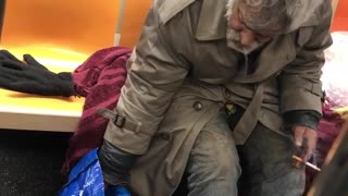 Old man smoking on subway train, drinks bottle of snapple