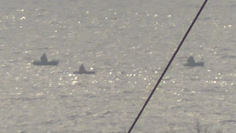 Fishermen on rubber boats catch sea fish