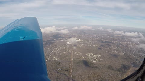 Flying above a few puffy clouds