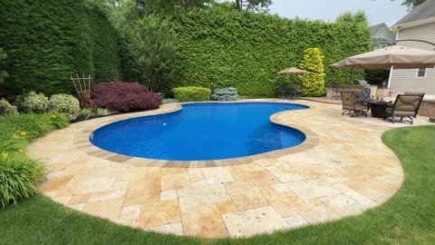 Free-Formed Vinyl Pool and Travertine Patio Installation in Smithtown