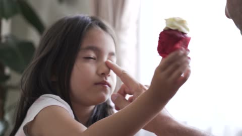 A Little Girl Getting A Nose Scratching