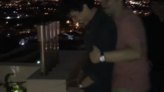 Drunk Guy Pushes Friend Over Roof onto DJ