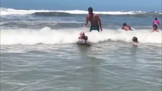 Courage's Baby Boy Surfing At The Edge Of Sea