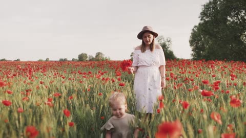 Mom and Daughter Walking on Red Poppy Flower Field
