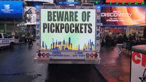 A NYPD billboard truck saying " BEWARE KF PICKPOCKETS "