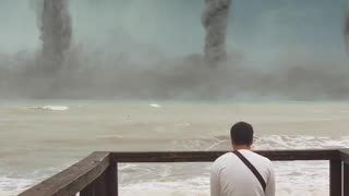 Man sitting and watching tornadoes on the horizon