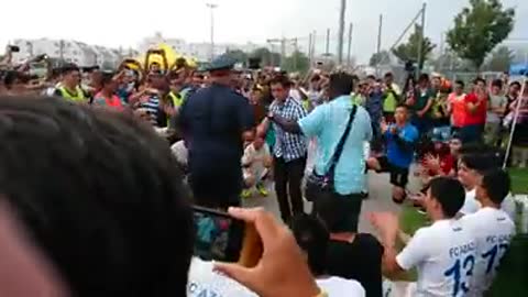 Police Officer Dances with Refugees