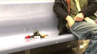 Old man empties his pockets and puts pills on subway seat