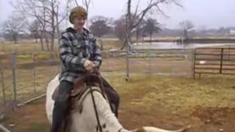 Timmy riding Star the Longhorn cow