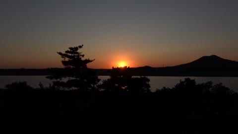 Red sunset, mountains and river trees