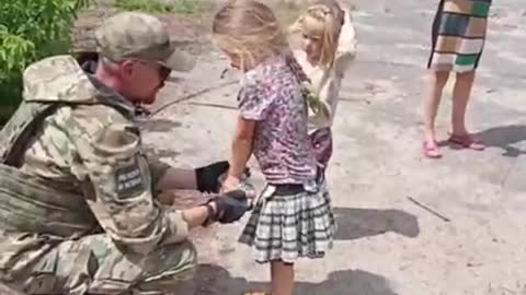 Soldier Gives Candy to Children