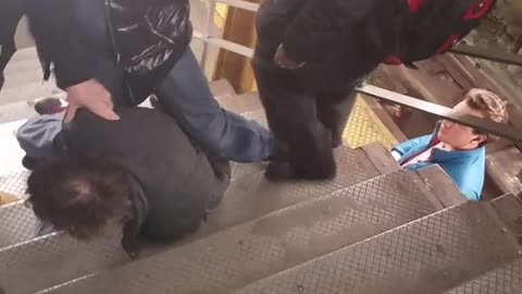Man tries to get in a fight and gets pinned down on subway stairs