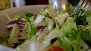 Mixing up a Greek Salad ready for serving