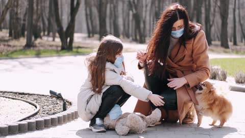 Mother and Daughter with Face Masks at the Park With Dog