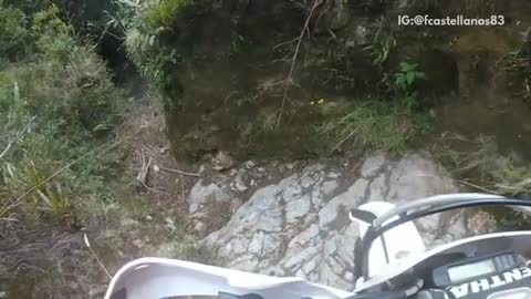 Motorcycle in narrow trail falls over