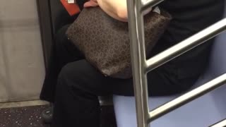 Lady clipping nails on subway