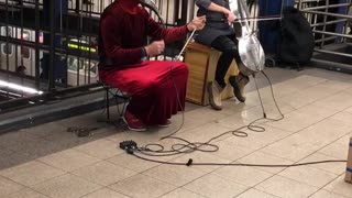 Metal animal helmet guys plays instruments in subway