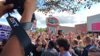 An angry crowd yells at Trudeau as he boards his campaign bus in Brantford, ON