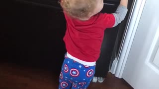 Baby Desperately trying to get in fridge